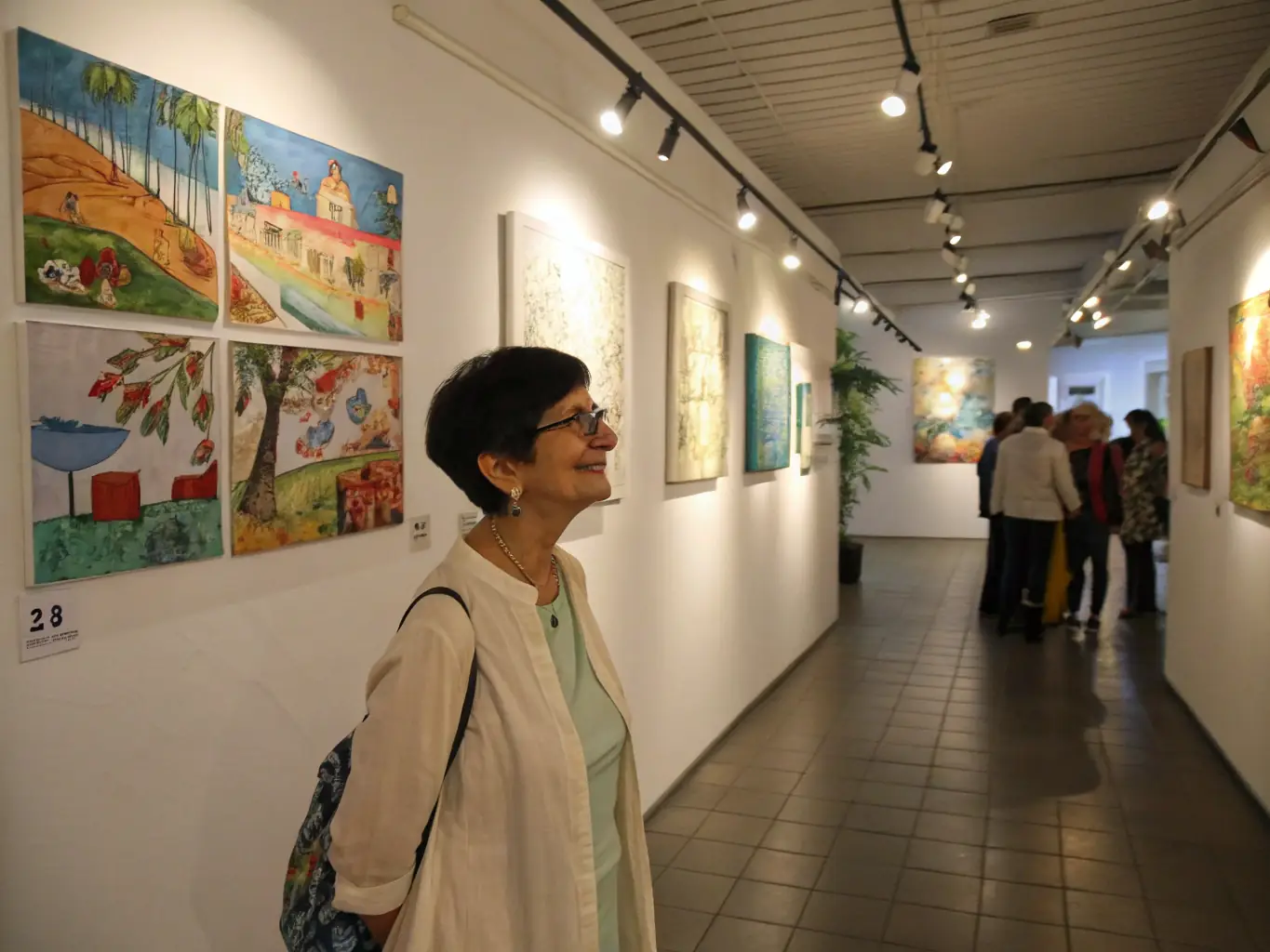 A photograph capturing a local artist showcasing their work at an ARTEMIS DIJON-sponsored exhibition, highlighting the support for local talent and artistic expression.